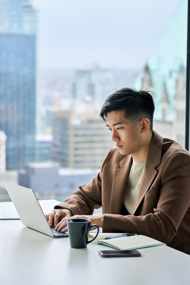 Young,Busy,Asian,Business,Man,Executive,Working,On,Financial,Strategy
